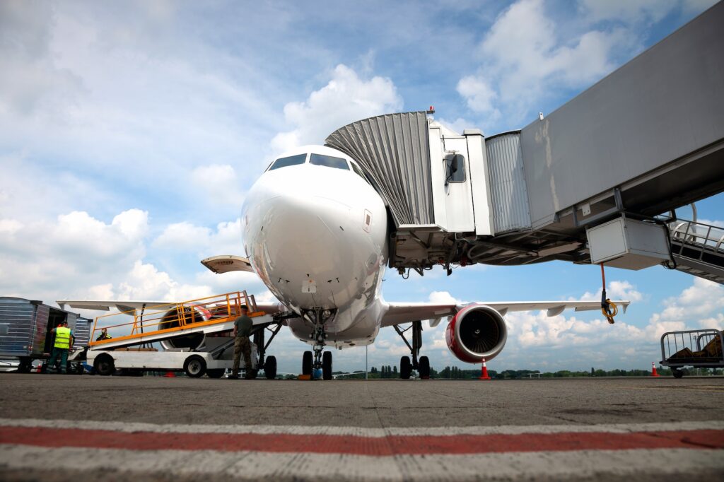 Boarding passengers on the plane through the boarding bridge. The plane lands at the international